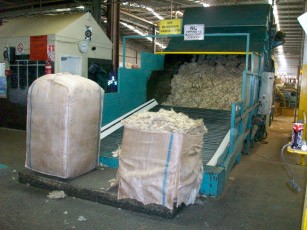 Bales being opened at the beginning of the process